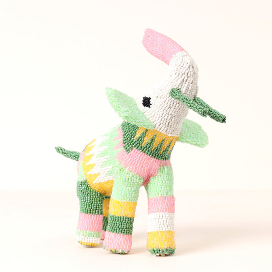 A handmade, beaded elephant sculpture, featuring pastel pink, green, yellow, and white striped patterns on a plain white background.