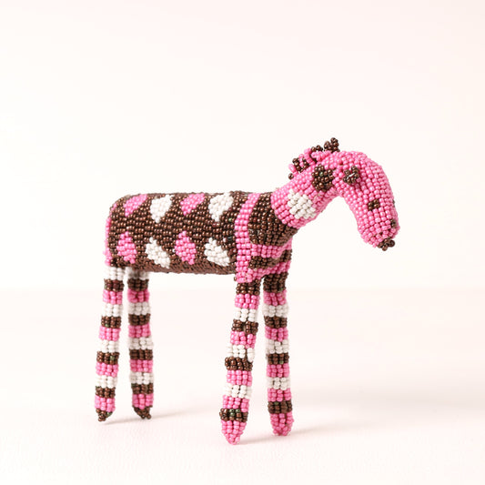 A handmade beaded zebra figurine featuring a pink and brown spotted body, pink and brown striped legs, and a pink head, crafted from beads on a plain white background.