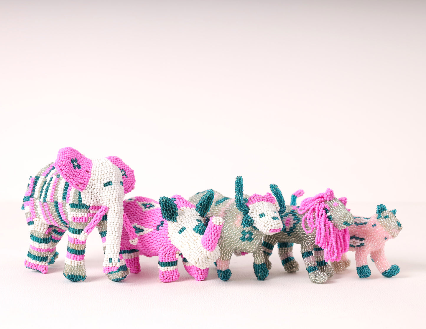 A handmade beaded big five sculpture, featuring pink, blue, white and silver. 