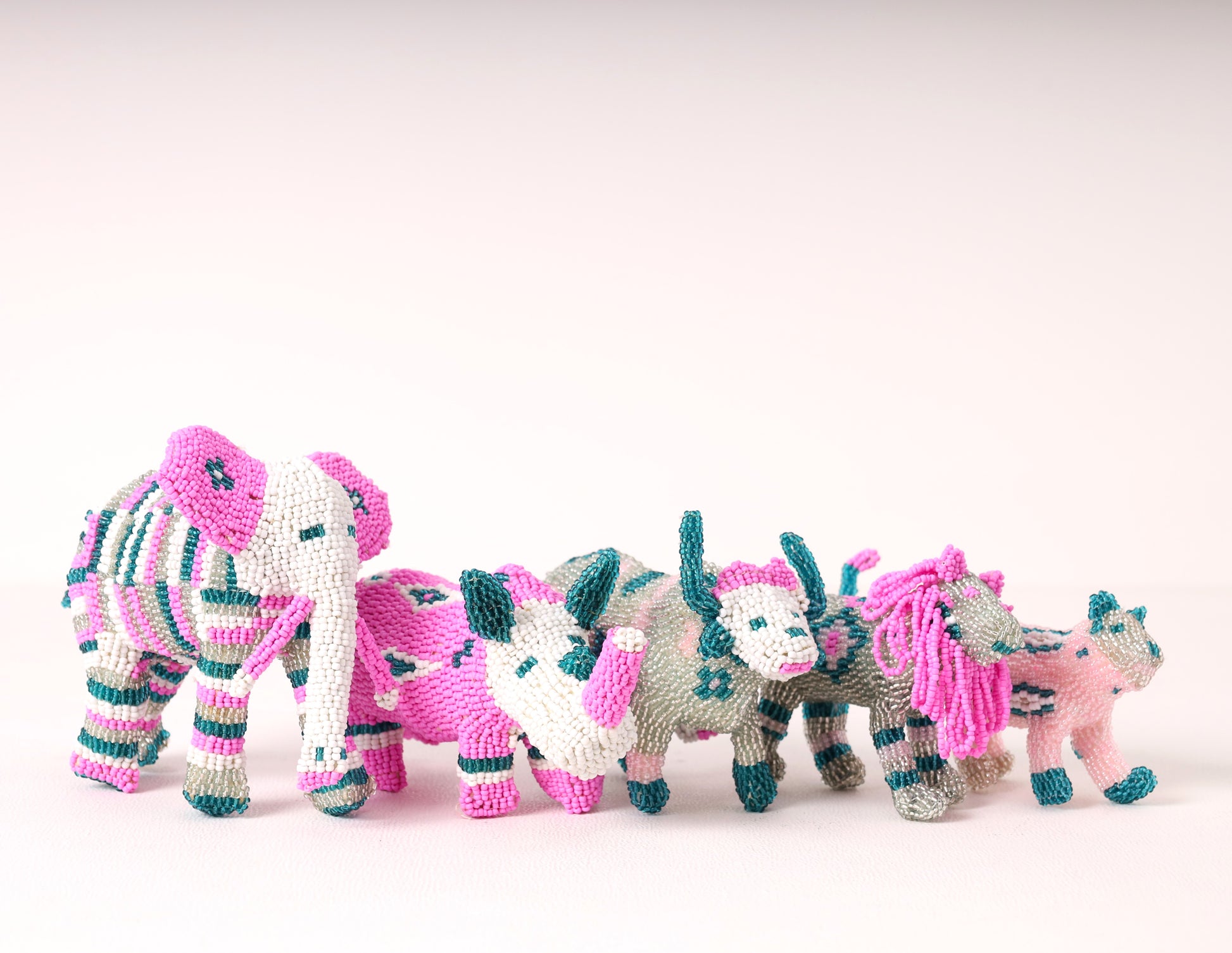 A handmade beaded big five sculpture, featuring pink, blue, white and silver. 